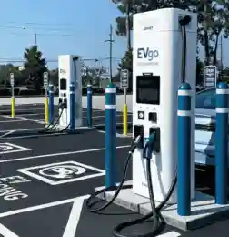 Electric vehicle charging station with multiple fast chargers and an electric car